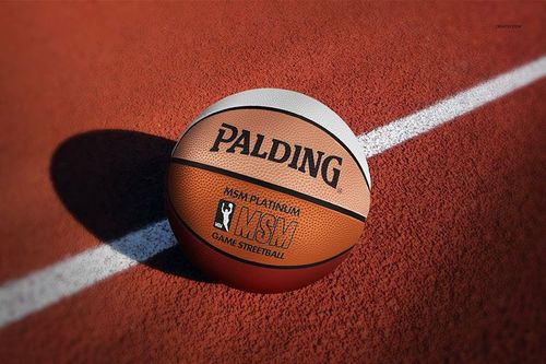 Realistic PSD mockup of a basketball ball featuring detailed surface and bold branding, placed on a sports field.