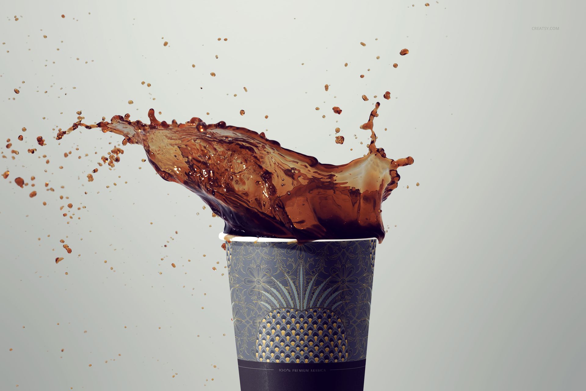 PSD mockup showing a coffee cup with a decorative blue pattern, highlighted by a burst of coffee spilling over the rim.