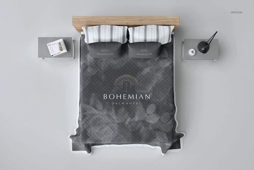 Quilted bed coverlet mockup in gray tones, shown from above with matching pillows and minimalist nightstands.
