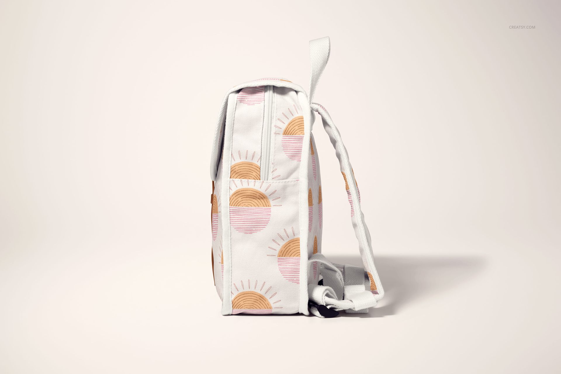 Side view of a kids backpack mockup with white fabric and pastel sun pattern, displayed on a light background.