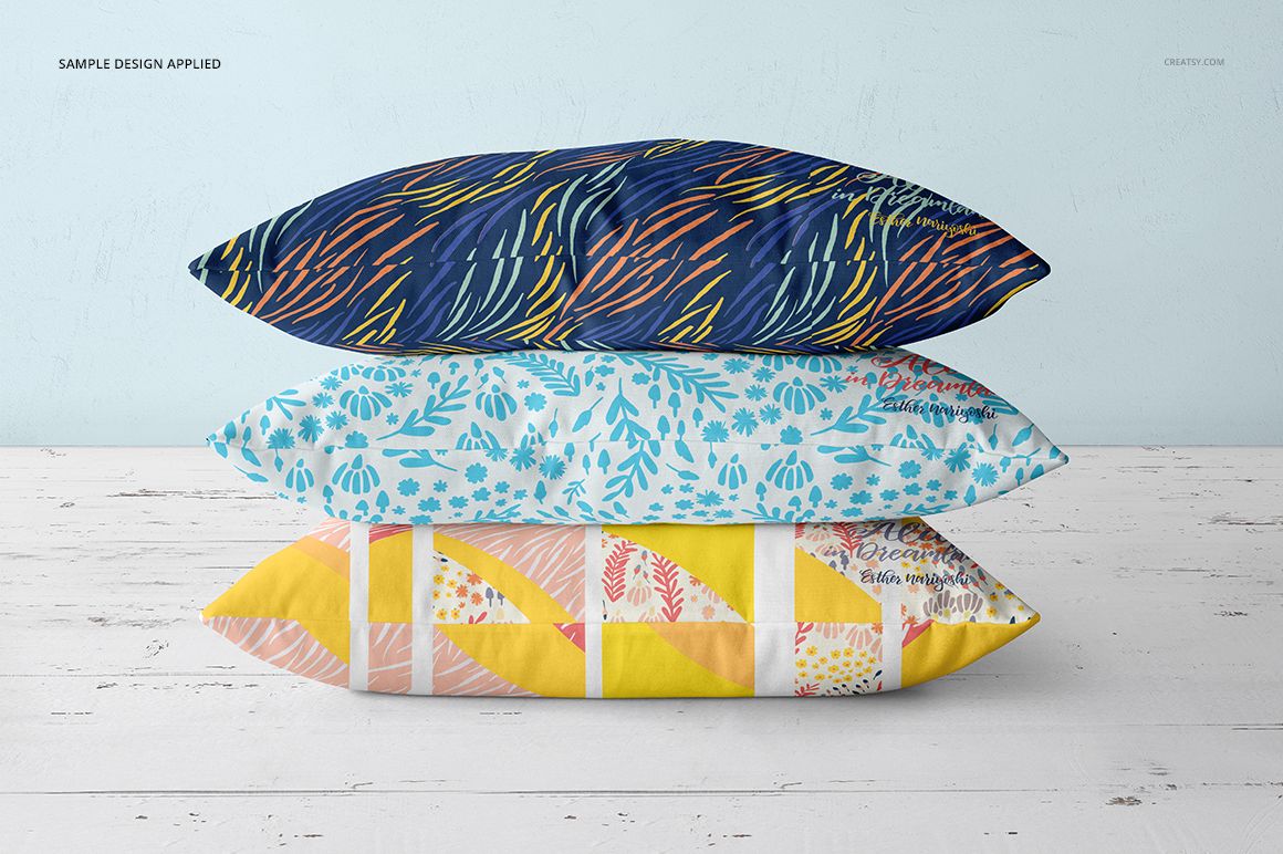 Three decorative throw pillows with blue, turquoise, and yellow designs, arranged horizontally in a realistic mockup scene.