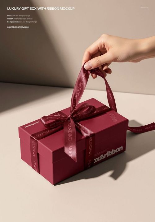 Luxury gift box mockup in deep red color, featuring a ribbon and clean, minimal scene with natural lighting.