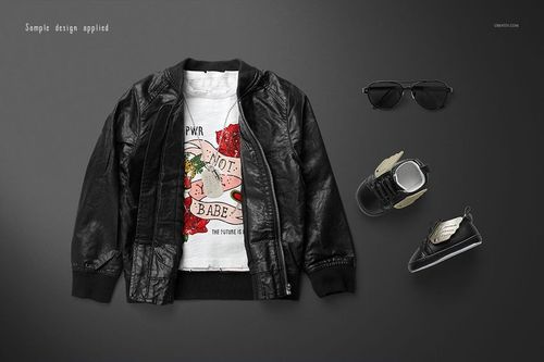 PSD mockup of kids rock-themed T-shirt styled with black jacket, matching shoes, and sunglasses on flat lay scene.