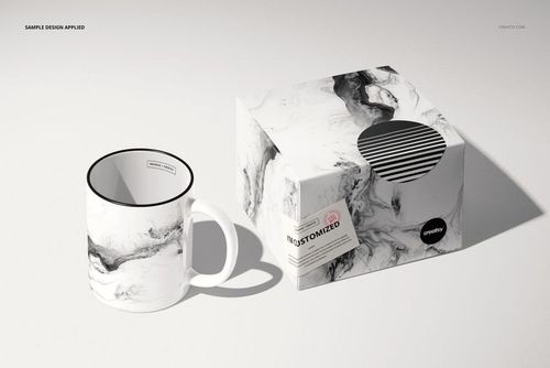 Ceramic mug featuring a black and white marble design next to a coordinating box, shown in a realistic mockup scene.
