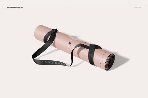 PU leather yoga mat mockup featuring a rolled mat in pale pink, black strap, and minimalist moon phase pattern.