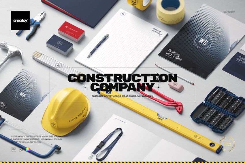Construction company identity mockup set featuring stationery, business cards, helmet, and tools on a light surface.