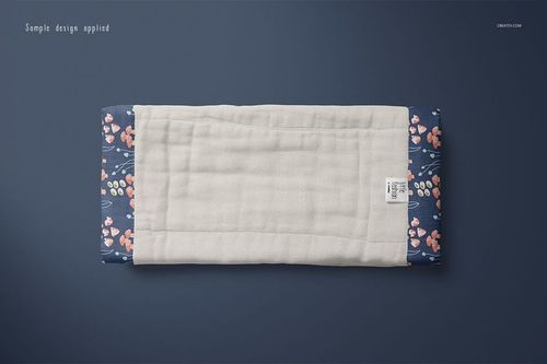Burp cloth mockup featuring a soft white middle section and navy floral sides, displayed flat against a dark surface.