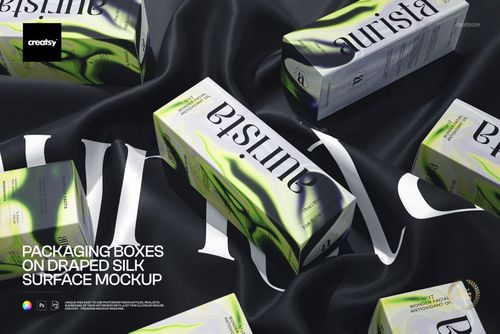 PSD mockup of packaging boxes with green accents placed on a luxurious black silk surface, showing various angles.