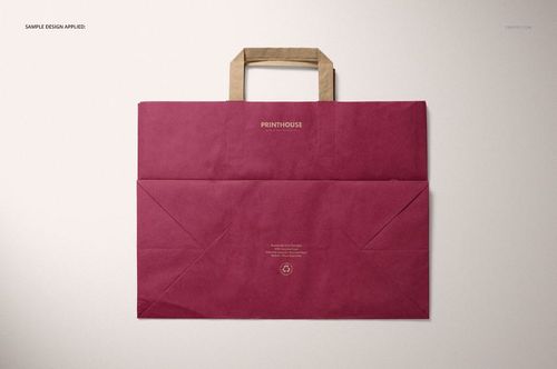Burgundy kraft paper bag mockup with folded handles shown from above, placed on a neutral background.