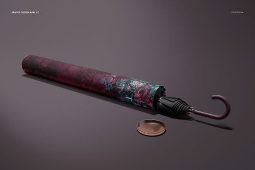PSD mockup of umbrella packaging with a colorful floral tube, curved handle, and round cap placed to the side.