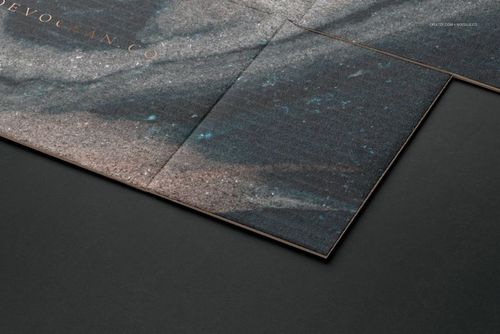 Detailed shot of a packaging box mockup with a marbled design in dark tones, shown from an angled perspective.