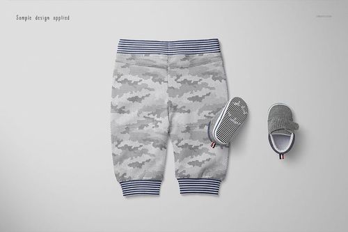PSD mockup showing baby sweatpants in gray camo with blue striped cuffs, displayed beside matching baby shoes.