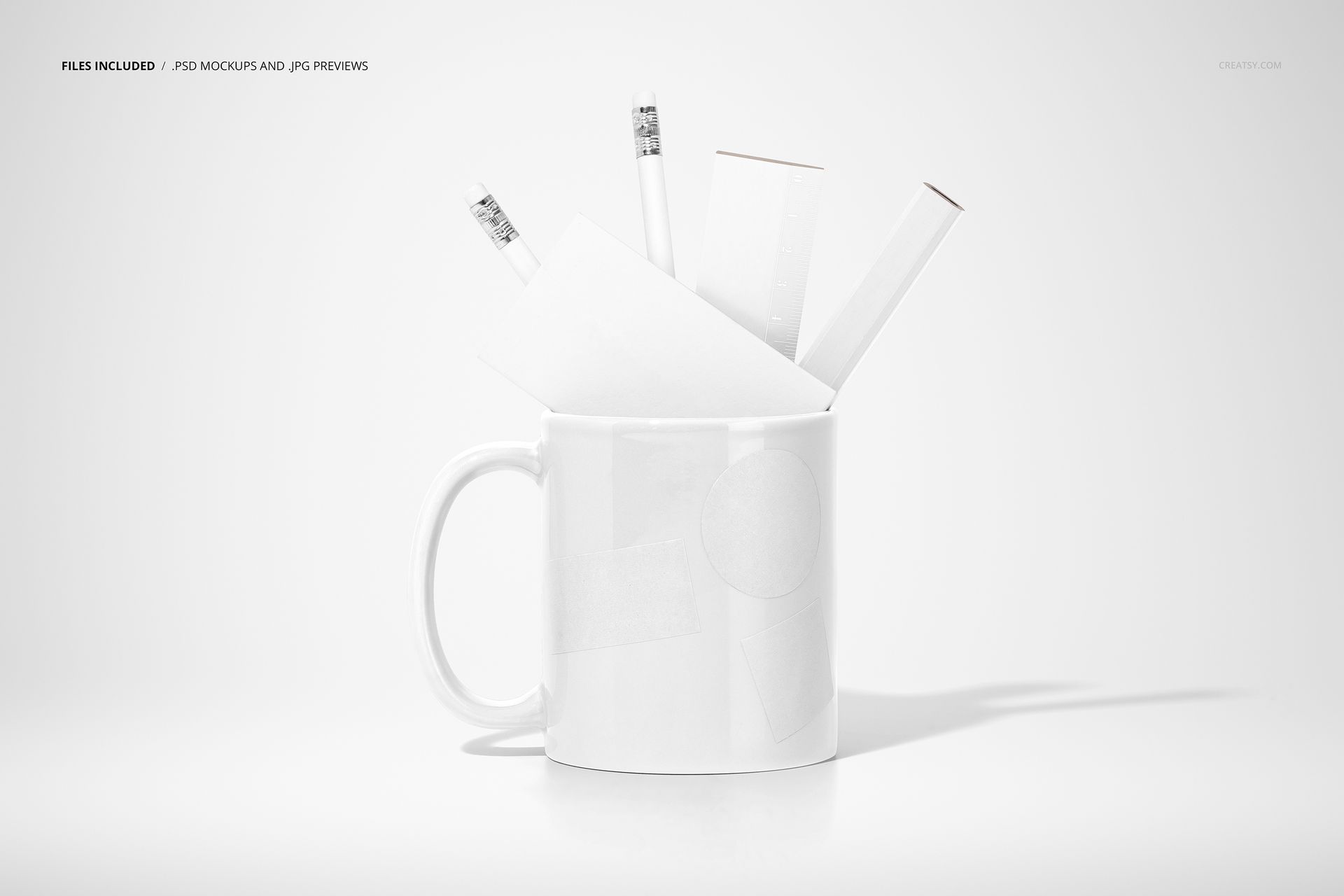 PSD mockup featuring a white mug with office supplies such as pencils and paper, set against a clean, white backdrop.