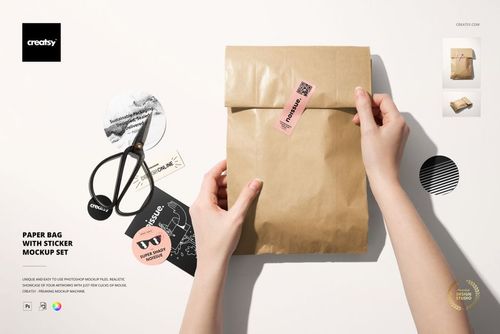 Paper bag mockup set featuring a kraft bag, stickers, and scissors arranged on a bright workspace, viewed from above.