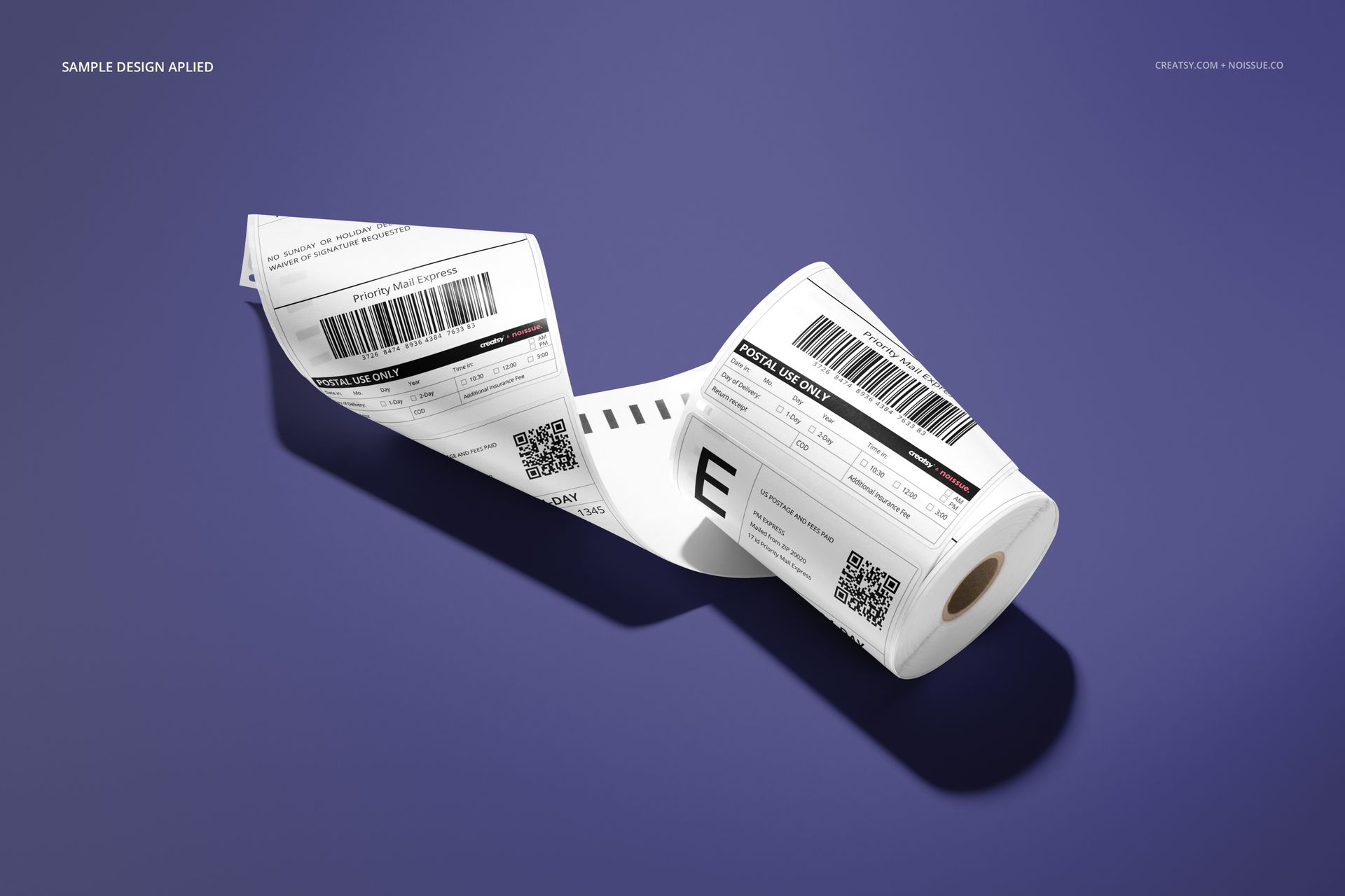Shipping label roll mockup with printed sample design, showing barcodes and text on a purple surface, angled perspective.