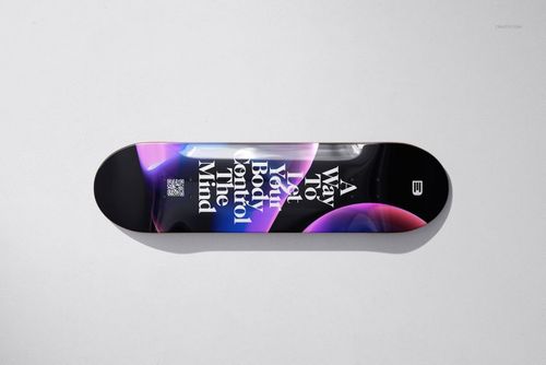 Top view of a skateboard deck mockup with glossy finish, displaying colorful abstract design and large white lettering.