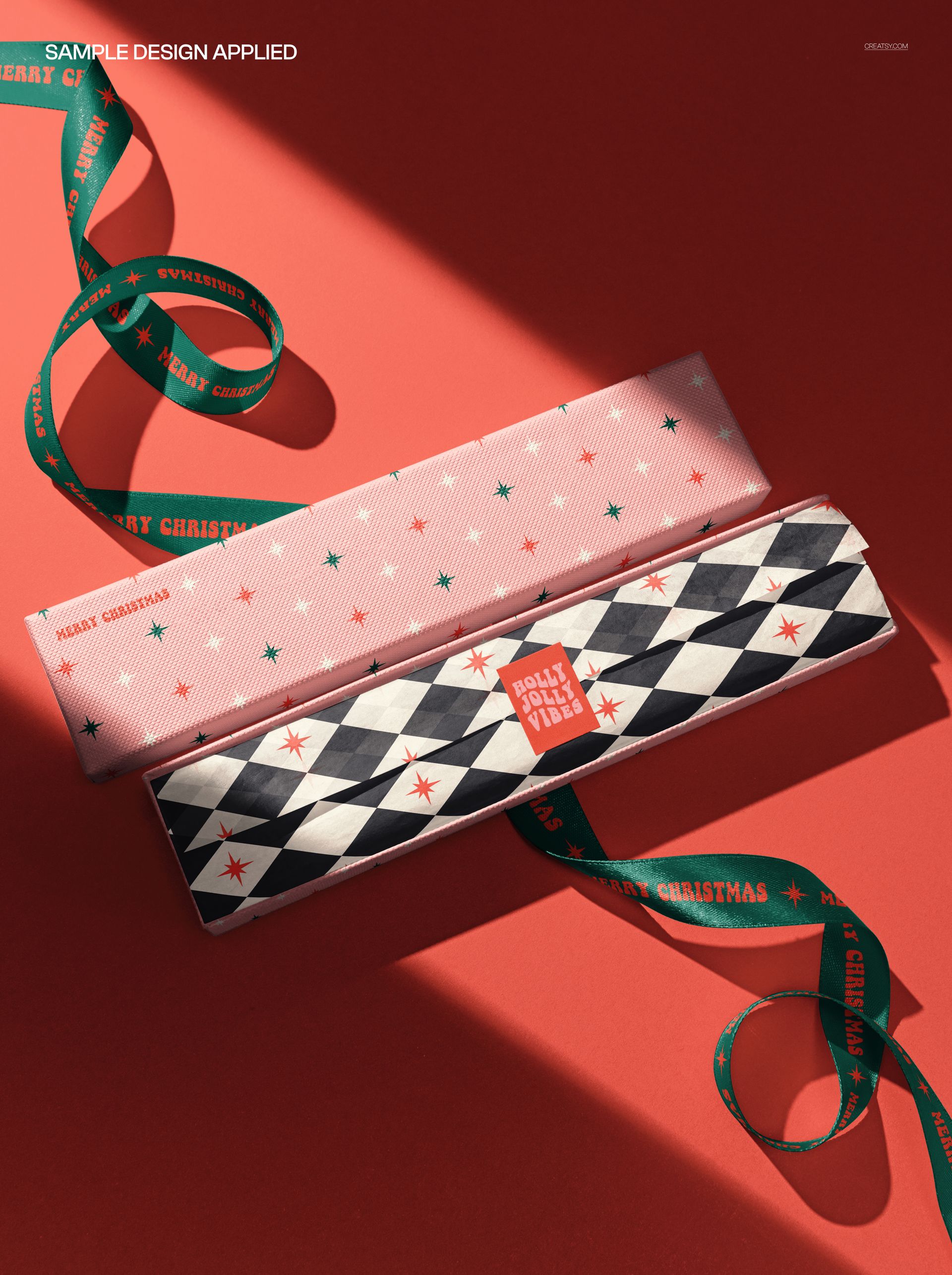 PSD mockup of packaging with two elongated gift boxes, one pink and one black, each with holiday-themed designs and ribbons.
