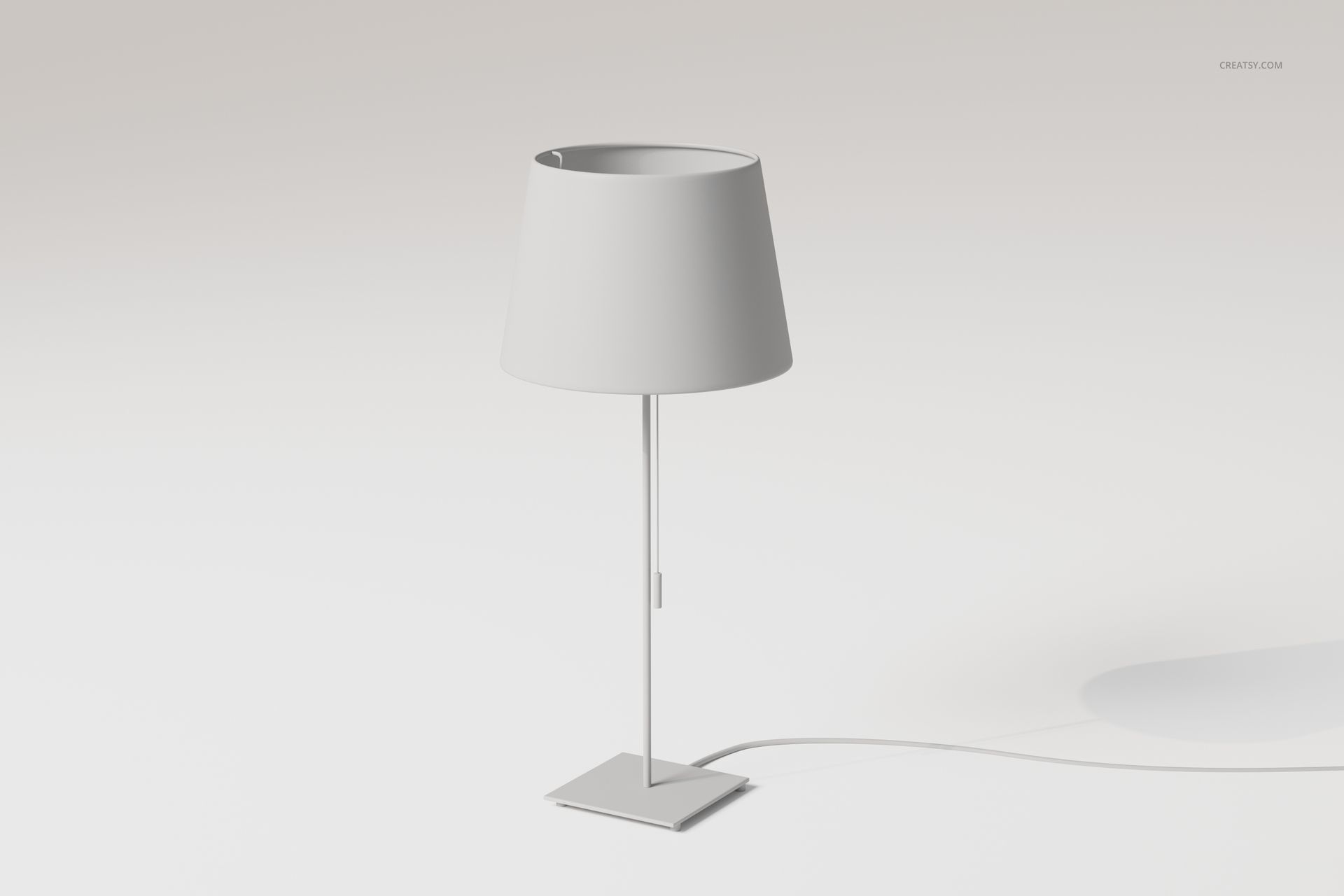 Modern pull cord table lamp with a cylindrical shade and slim metal base, shown in a minimal white setting.