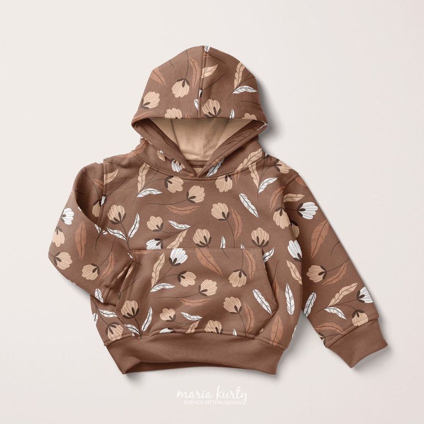 Kids hoodie mockup featuring a brown pull-on hoodie with a meadow flowers pattern in beige and white, shown on a light background.