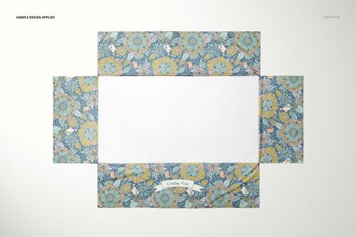 Crib skirt mockup with a rectangular white center and floral patterned borders in blue, yellow, and pink tones, top view.