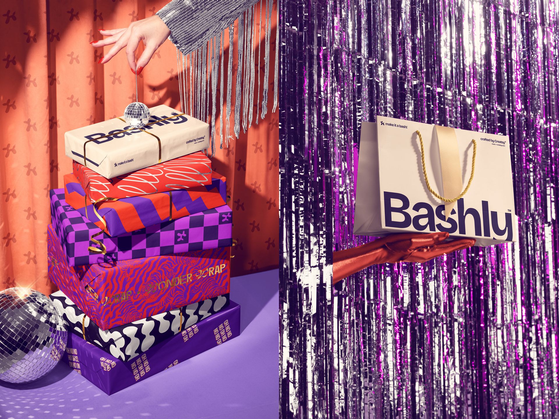 Hand holding a Bashly gift bag with rope handles against a backdrop of silver tinsel, party-themed mockup scene.