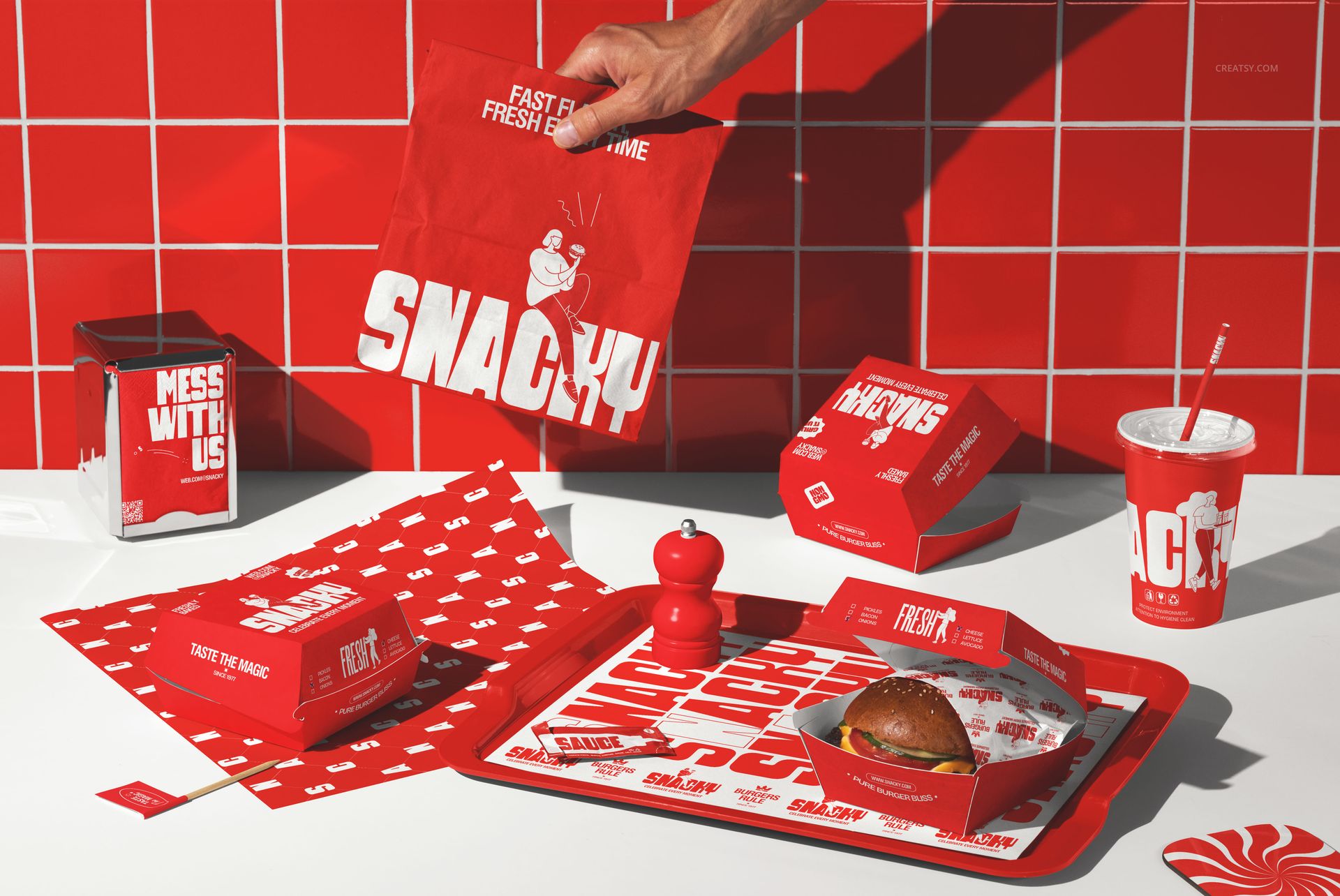 Fast food restaurant branding mockup featuring red packaging, burger box, drink cup, tray, and napkin in a tiled setting.