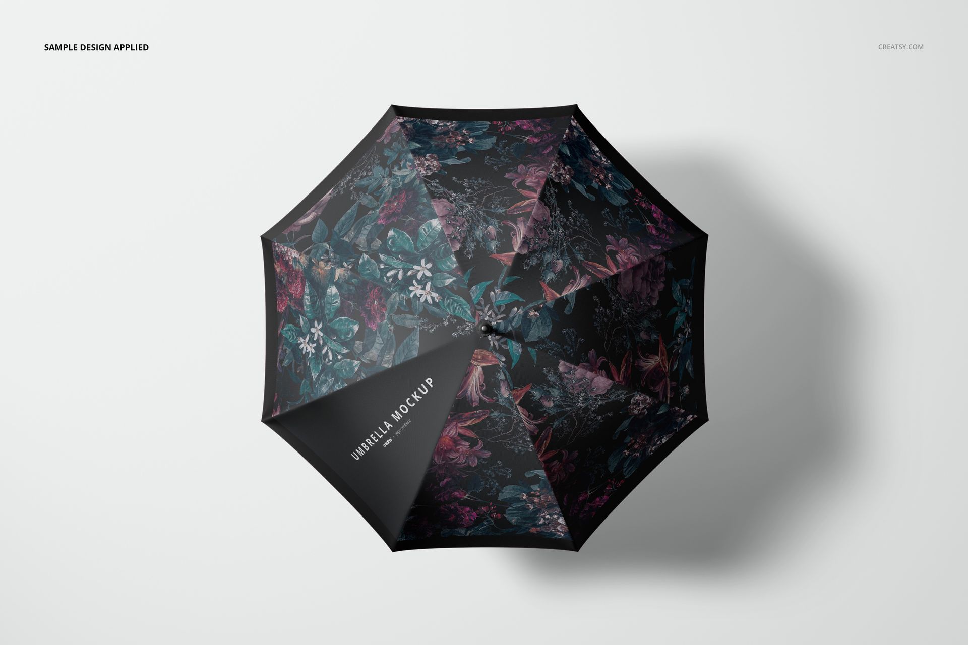 PSD mockup of an umbrella with multicolored flower motifs, shown from a bird’s-eye perspective on a simple backdrop.