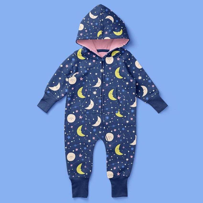 Baby toddler fleece onesie mockup featuring a navy blue hooded suit with moon, star, and cloud patterns on a solid light blue background.