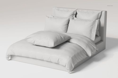 Front view of a bed with ruffled pillows and bedding set in solid white, displayed in a minimal studio setting.