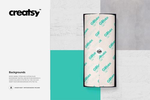 PSD mockup showing a gift box covered in white tissue paper with teal lettering, set against a textured background.