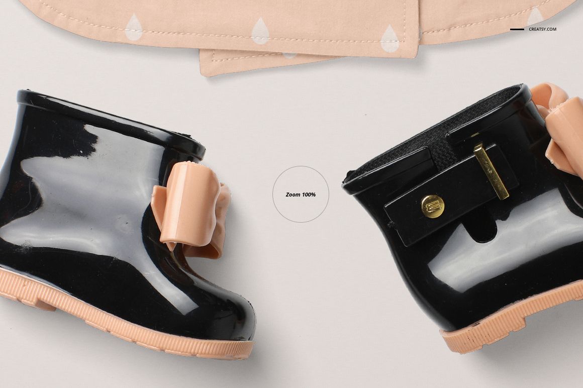 PSD mockup featuring a pair of glossy black baby boots with beige bows, arranged on a light background with coat details.