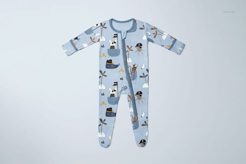 Blue baby footie mockup with whimsical animal and boat print, shown from the front on a light neutral background.