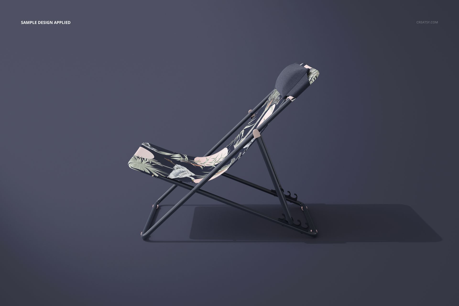 Side view of a folding beach chair mockup featuring a black frame and floral print fabric seat on a solid backdrop.