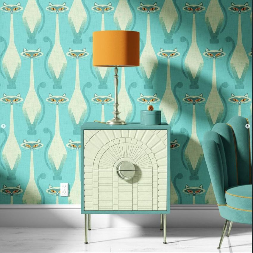 Drum lamp shade mockup featuring an orange lamp on a cabinet, with a teal cat-patterned wallpaper and teal armchair.