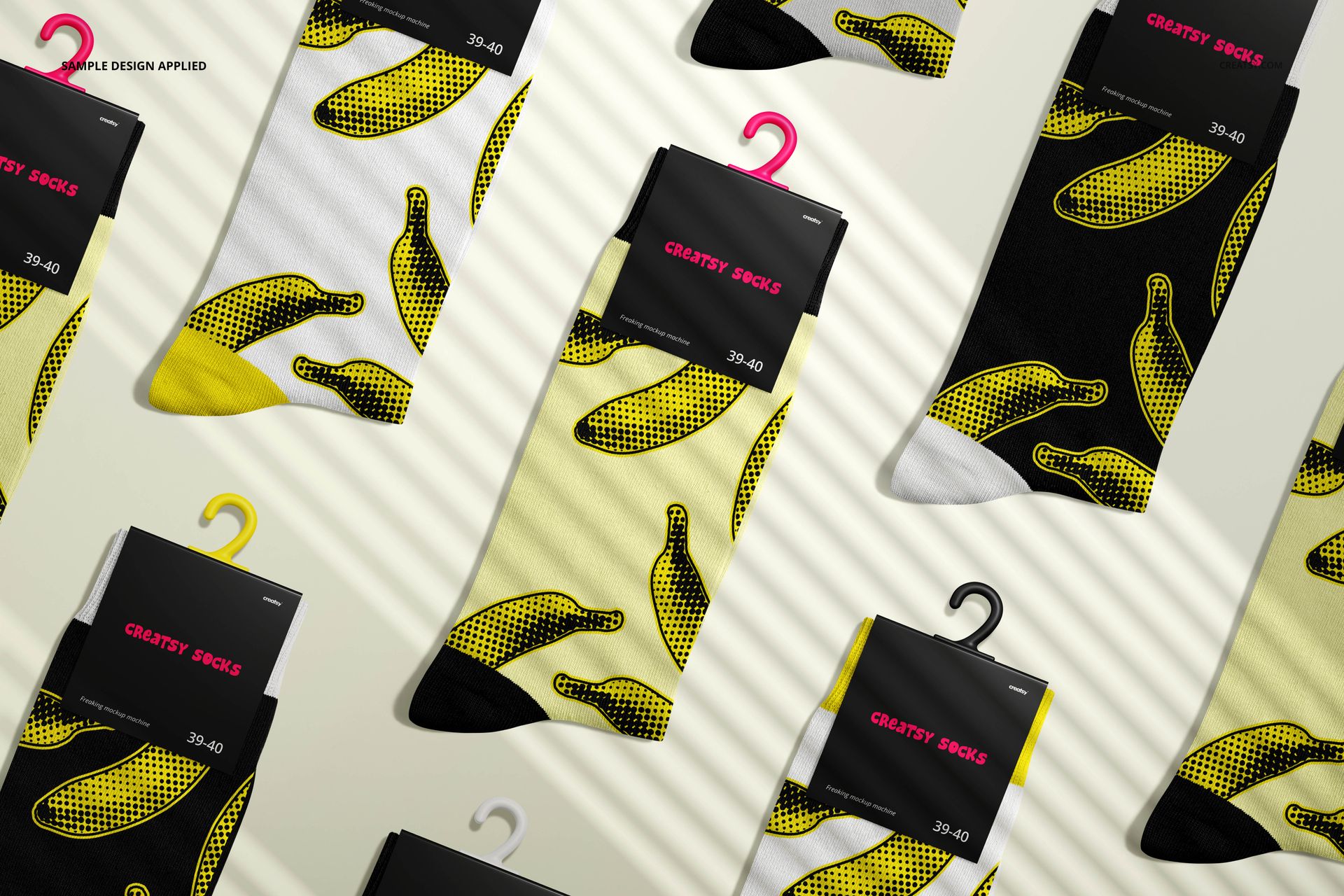 Medium cuff socks mockup featuring multiple pairs with yellow and black banana patterns, viewed from above on a light surface.