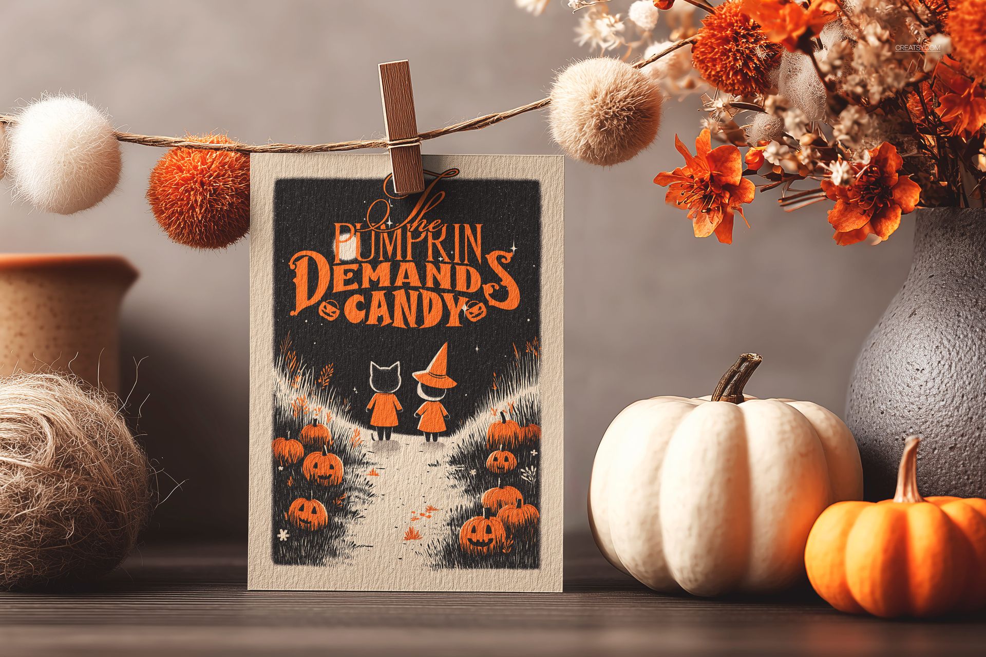 Halloween greeting card mockup featuring an illustrated card with pumpkins and autumn decorations on a wooden table.
