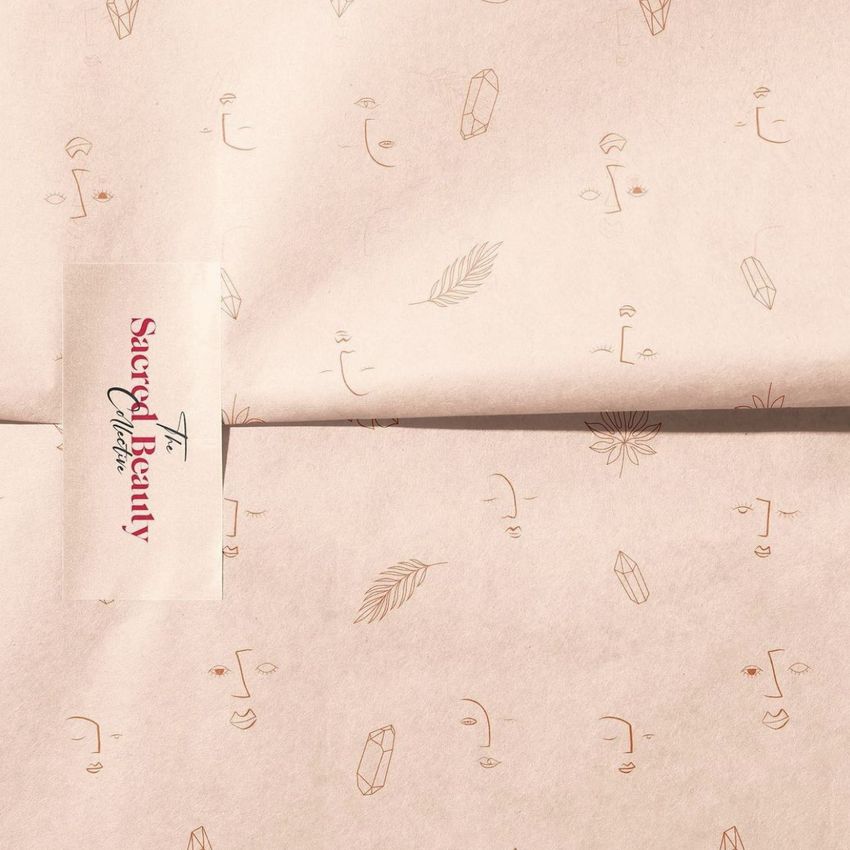 Sticker mockup featuring a rectangular label with red and black text on beige wrapping paper decorated with minimal line art.