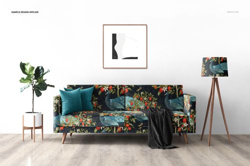 Interior mockup featuring a floral-patterned sofa, teal cushion, framed artwork, lamp, and plant on wood floor.