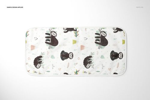 Top view of a minky burp cloth mockup displaying cartoon sloths and small colorful shapes on a white surface.