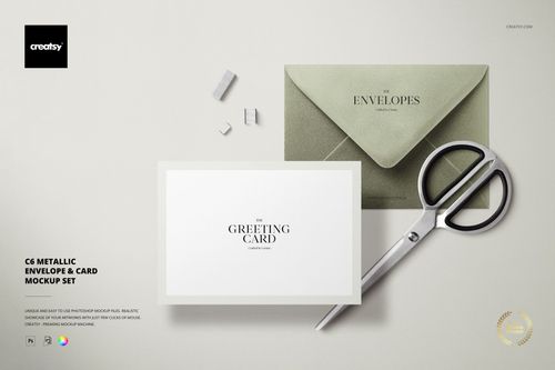 C6 metallic envelope and card mockup set displayed on a light surface with scissors and paper clips, top view.