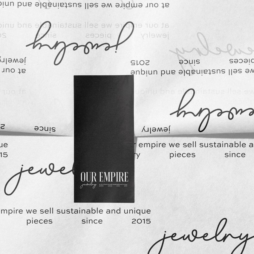 Wrapping paper mockup with black rectangular sticker placed at the center, featuring scattered handwritten and printed text.