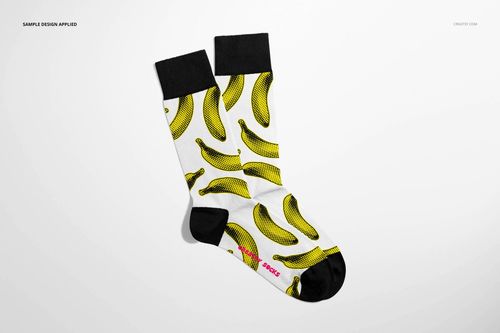 High cuff socks mockup displayed from above, showing black accents and a bold yellow banana print on white fabric.