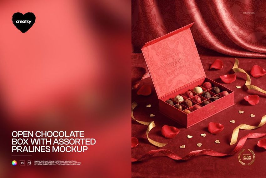 PSD mockup of a red chocolate box filled with pralines, set on luxurious red fabric with decorative heart-shaped accents.