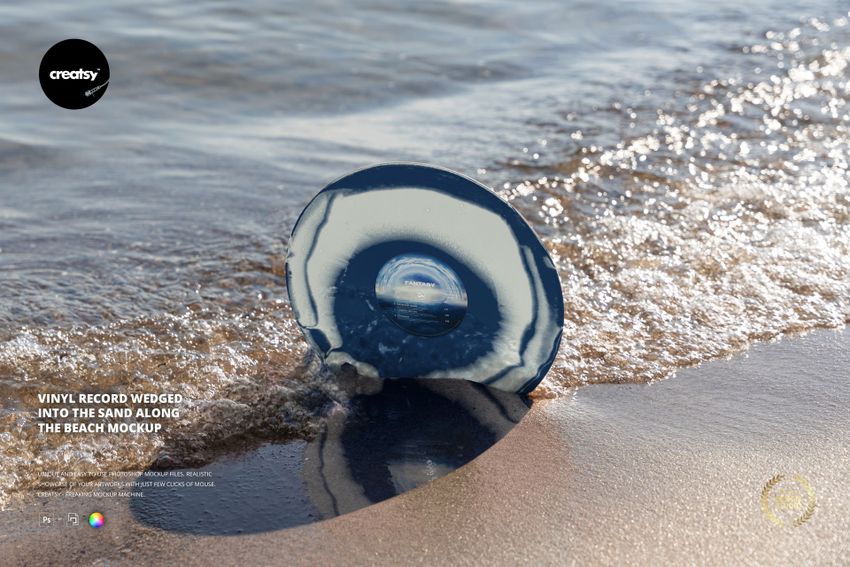 PSD mockup of a vinyl record stuck in sand near the water’s edge, showing ripples and reflections under natural light.
