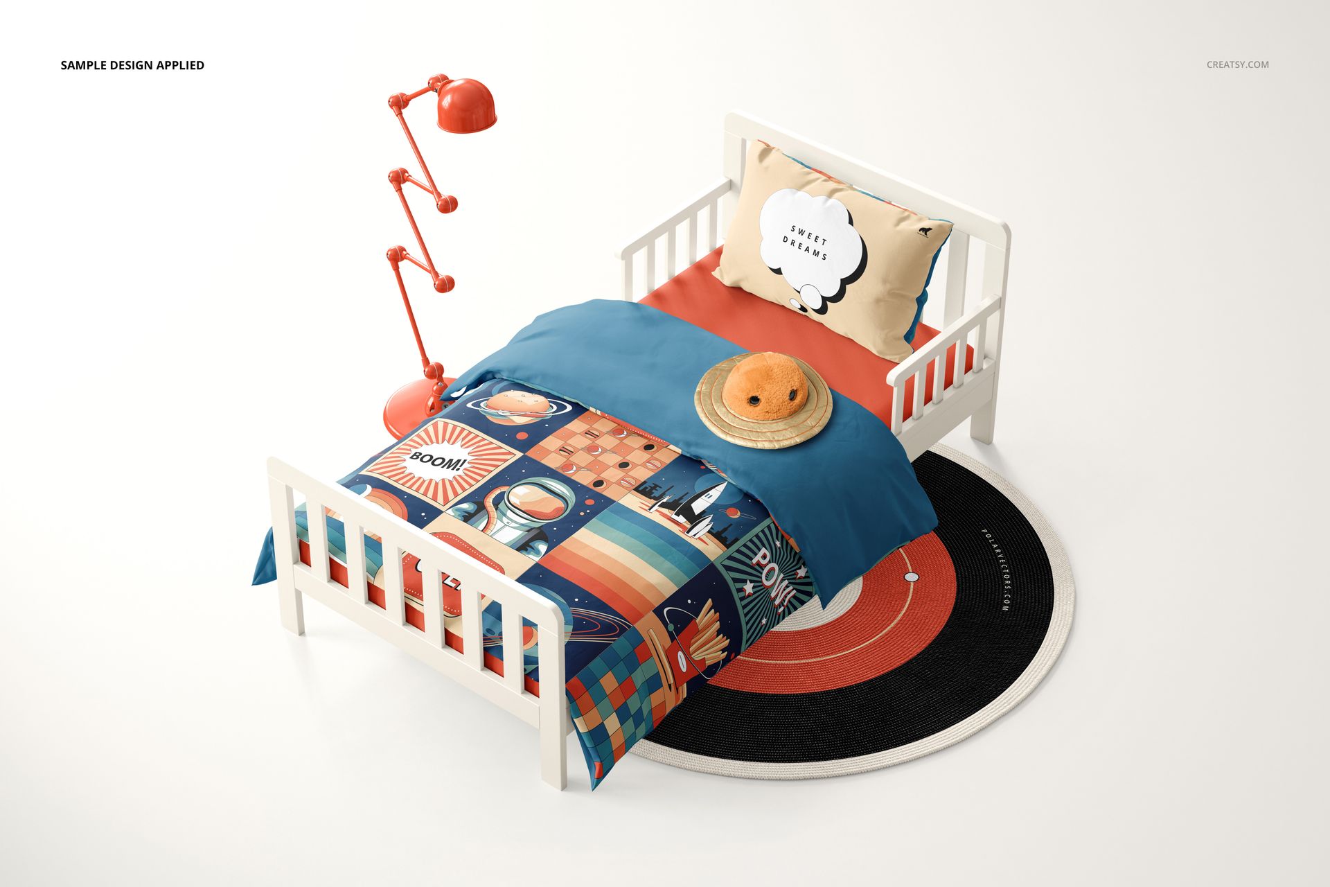 Toddler bedding set mockup with a white bed, colorful patterned duvet, orange lamp, and round rug in a studio setting.
