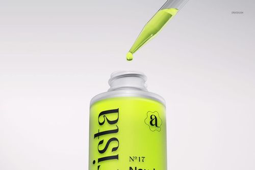 PSD mockup showing a dropper bottle with vivid yellow contents and a pipette dispensing a single drop, isolated on white.