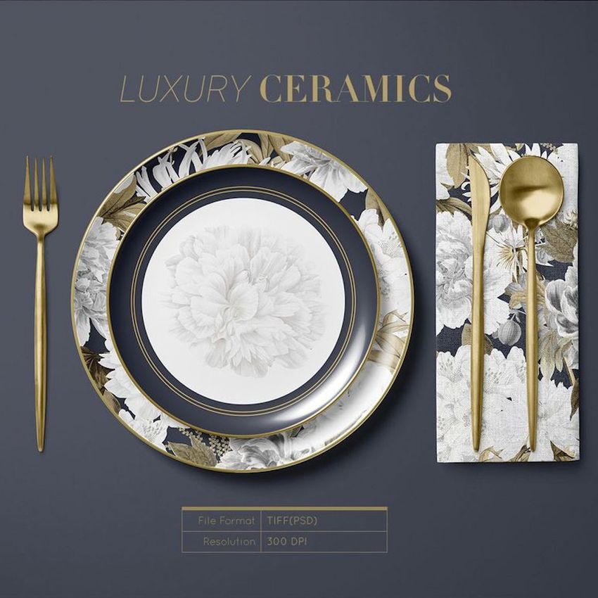 Placemat napkin plate mockup showing a floral-patterned plate, matching napkin, and gold cutlery on a dark surface.