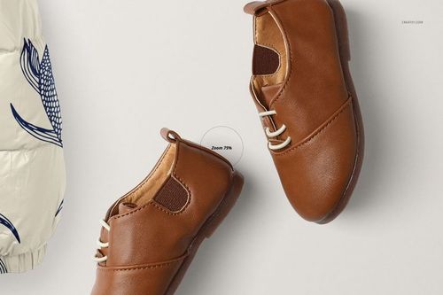 Kids winter set mockup featuring a pair of brown leather shoes with white laces, top view on a light background.