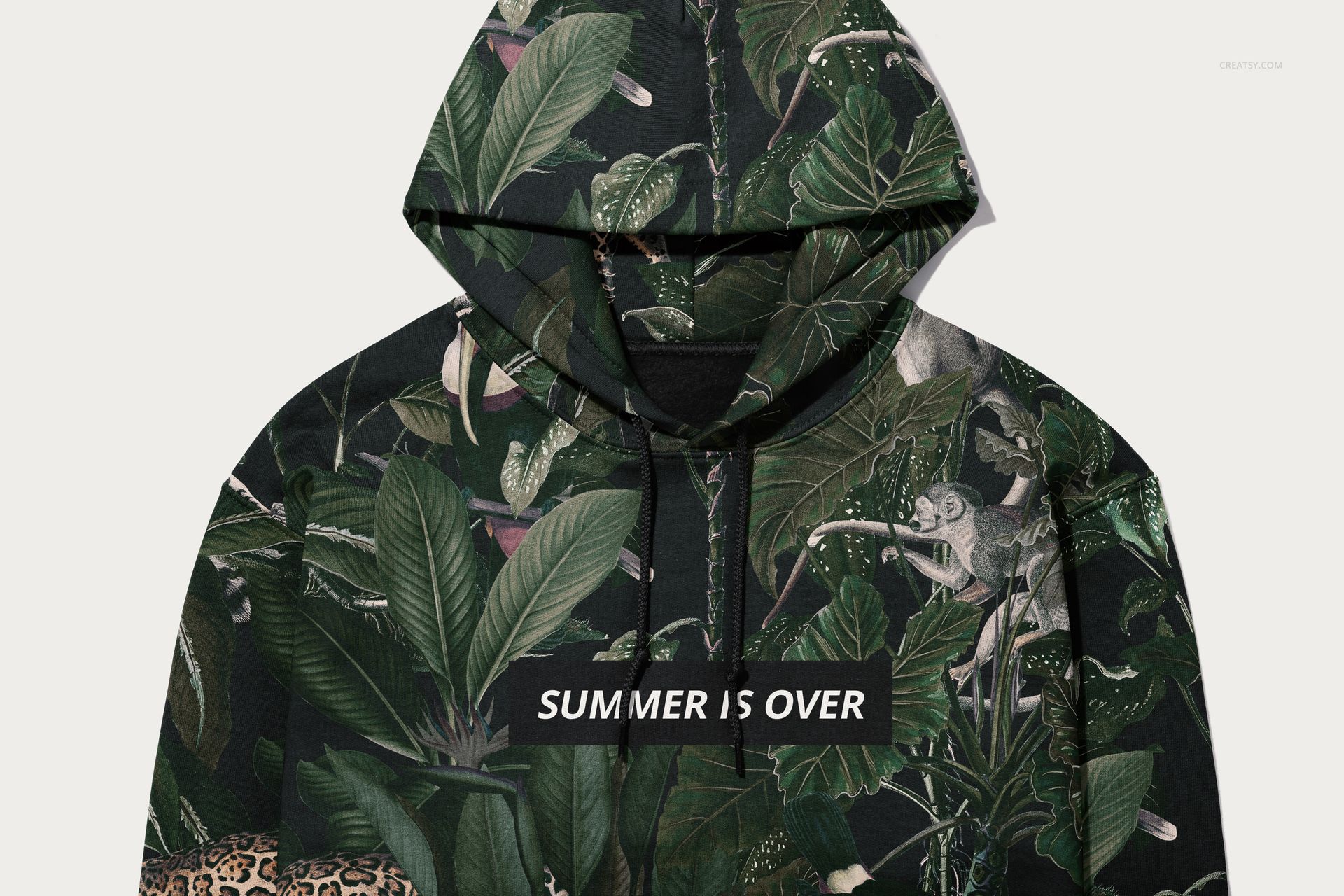 Front view of a Gildan 18500 hoodie mockup featuring a dark green tropical leaf pattern and bold white text on the chest.