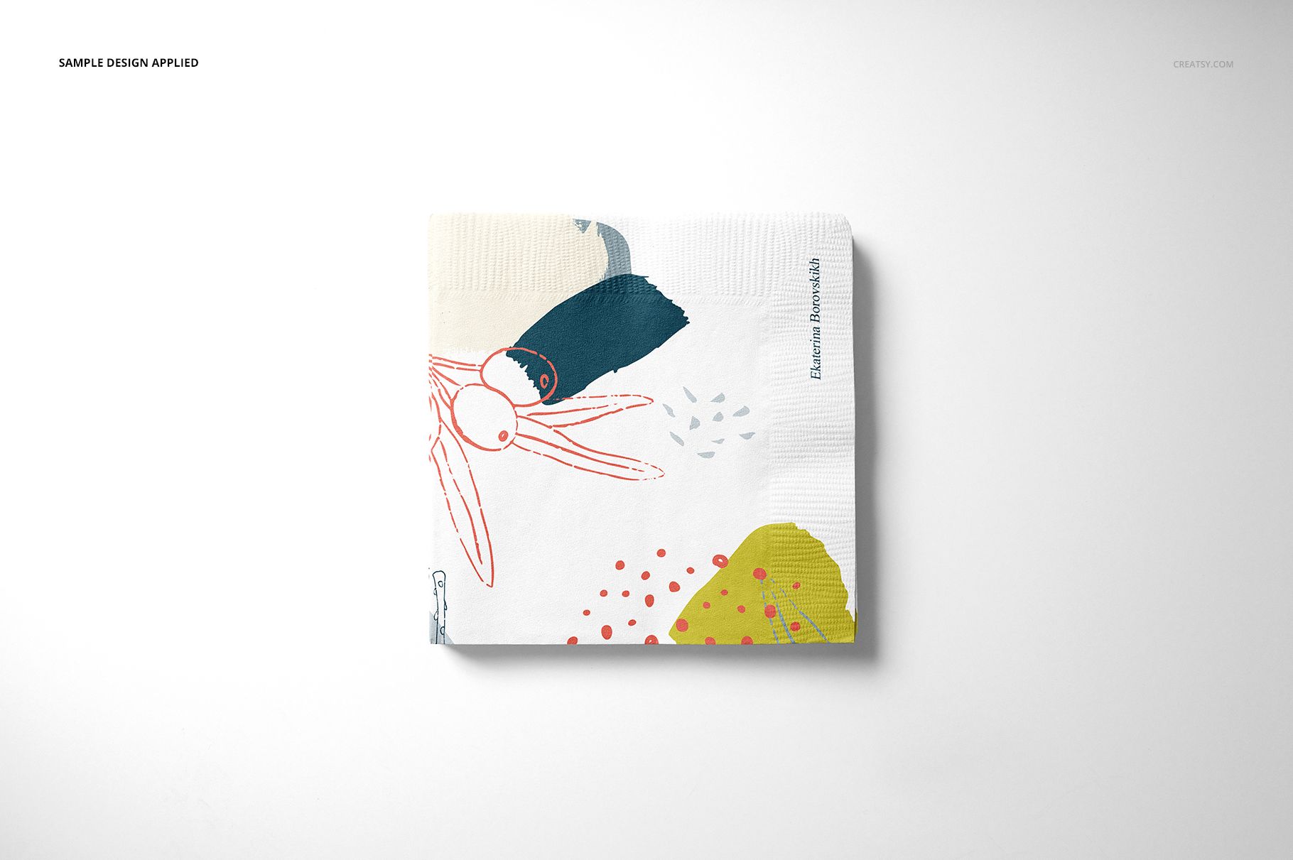 Square paper napkin with abstract colorful design, viewed from above on a plain white background, mockup set.